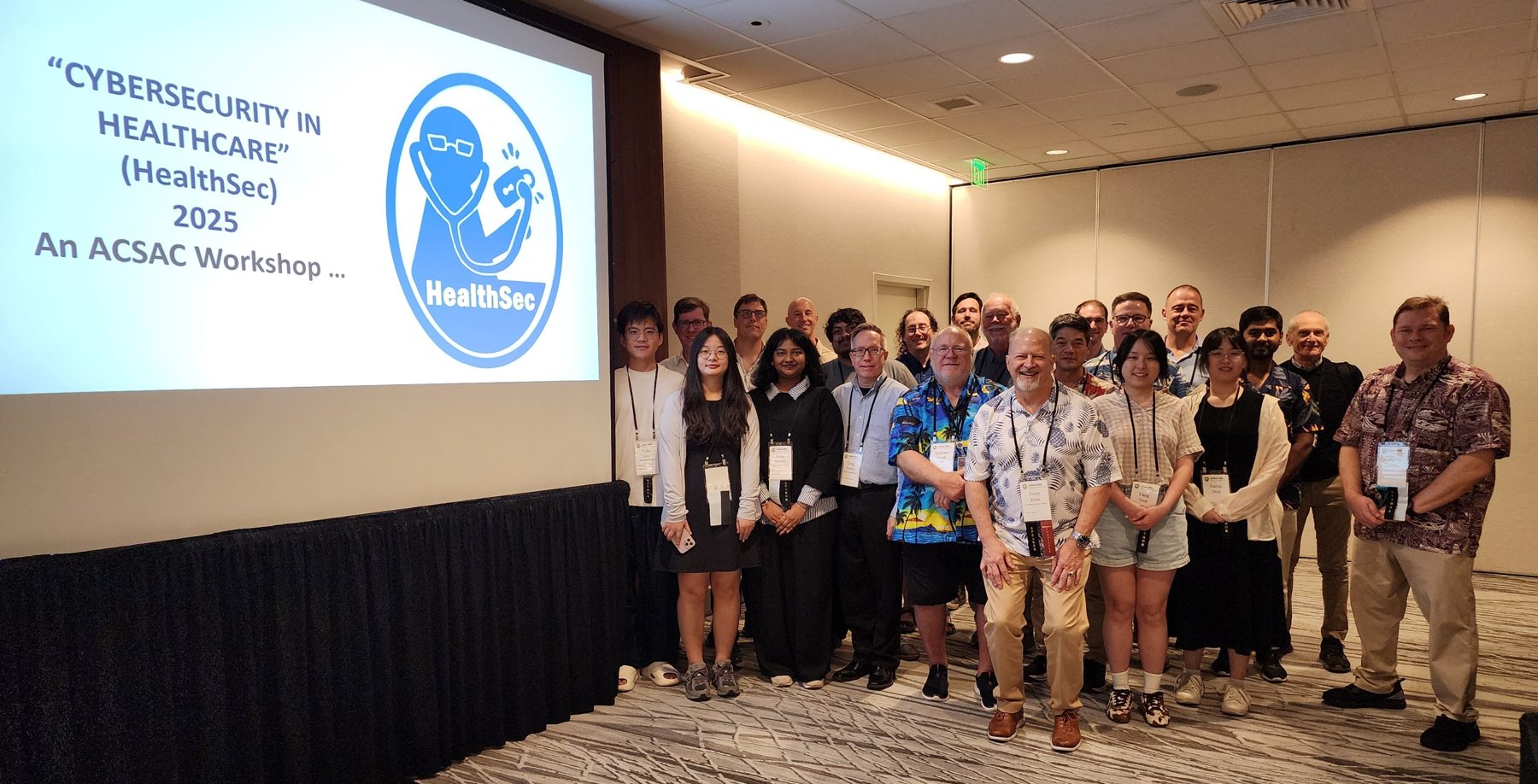 Attendees of the HealthSec 2025 workshop gathered in front of the workshop title slide